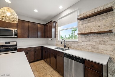 Kitchen with open shelves, dark brown cabinetry, stainless steel appliances, recessed lighting, and light tile patterned flooring
