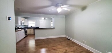 Kitchen featuring dark countertops, baseboards, ap