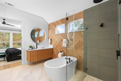 Ensuite bathroom featuring vanity, a freestanding