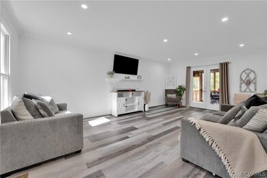Living room featuring french doors, crown molding,
