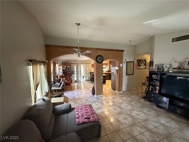 Living room with arched walkways, vaulted ceiling,