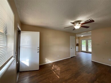 Spare room with french doors, dark wood-type floor