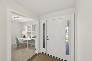 Entry with sidelight windows on each side allow natural light at the entry