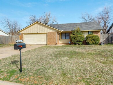 Single story home with a front yard and a garage