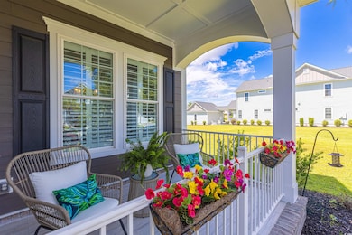 Covered porch featuring a yard