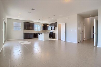 Unfurnished living room featuring light tile patt