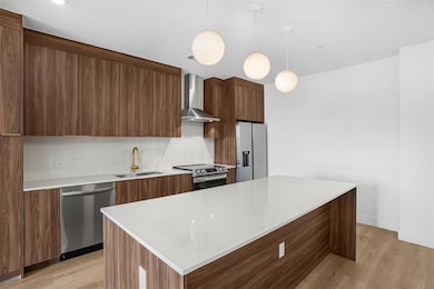 Kitchen with stainless steel appliances, wall chi