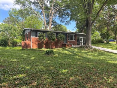 Single story home with brick siding and a front la