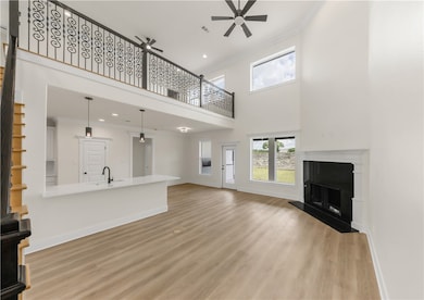 Unfurnished living room with a ceiling fan, light