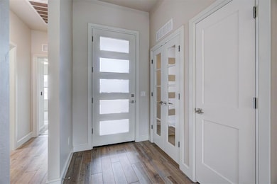 Entrance foyer with light hardwood / wood-style fl