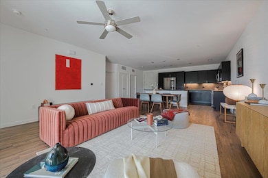 Living room featuring ceiling fan and wood finish