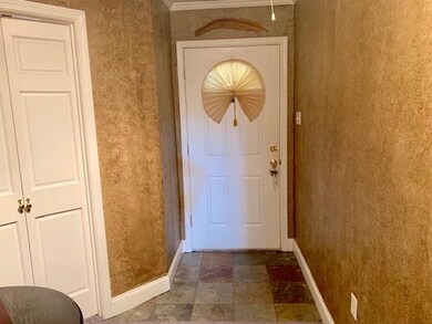 Foyer has slate floors and faux painted walls.