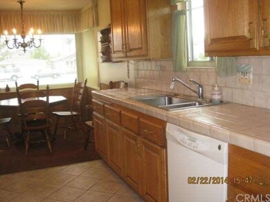 The kitchen is warm and homey with oak cabinetry a