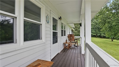 Wooden porch featuring a yard