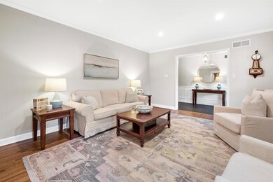 Living room featuring crown molding and hardwood /
