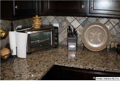 Kitchen has tile Backsplash and Granite counter to