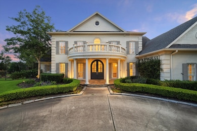 The custom arched wooden double front doors are fl