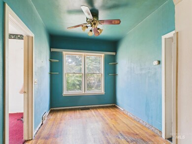 Unfurnished room with hardwood / wood-style floors and a ceiling fan