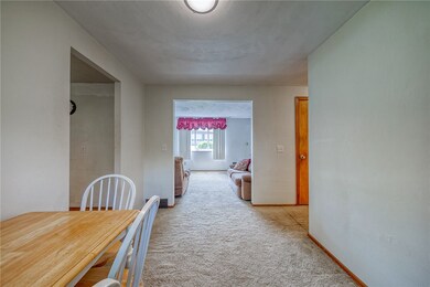 Dining area situated between living room and kitch