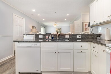 Kitchen featuring crown molding, a sink, white dis