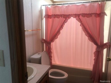 Full bath with shower / bath combination with curtain and vanity