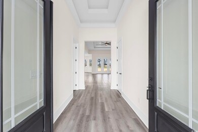 Corridor with light wood-type flooring and a raise