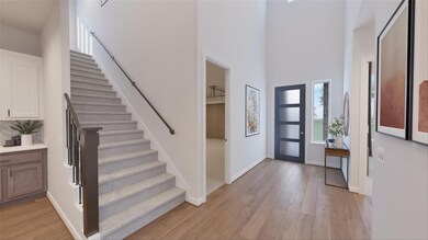 Entryway featuring stairs, light wood-type floori
