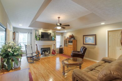 Living Room Features Gleaming Hardwood Floors, Vaulted Ceiling, And Recessed Lighting 