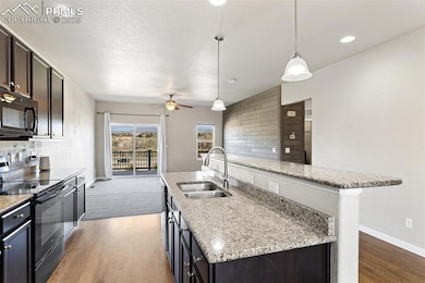 Kitchen with black appliances, a center island wit