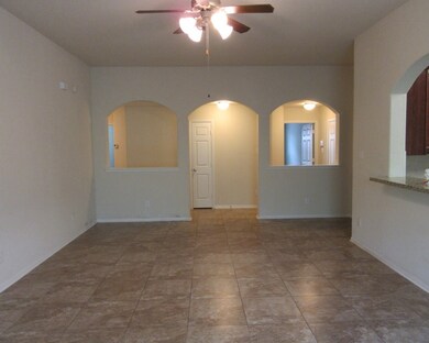 Large living room with tile flooring and ceiling fan