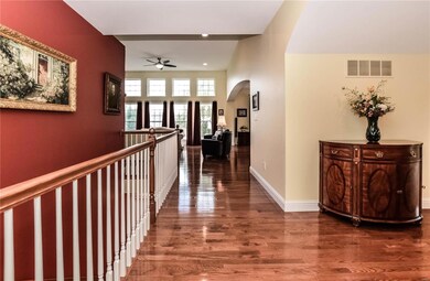 Extended foyer with gleaming hardwood flooring.