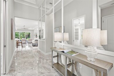 Corridor featuring crown molding, marble finish ti