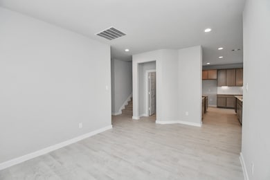 Make memories gathered around the table with your family and friends! This spacious dining room features elegant flooring, custom paint, and adjacent to family room and kitchen for open concept feel. Sample photo of completed home with similar floor plan. Actual colors and selections may vary.
