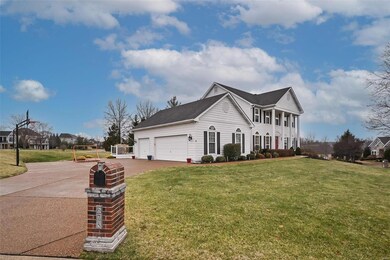 Brick mailbox, large driveway and basketball hoop