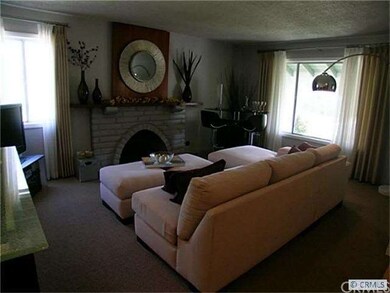 Front-facing living room with a fireplace and larg