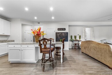 Kitchen featuring a kitchen island, white cabinetr