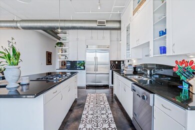 Kitchen featuring concrete floors, open shelves, 