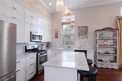 Light and airy kitchen features Carrera marble cou
