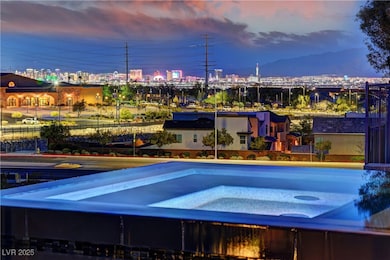 Pool at dusk with a city view