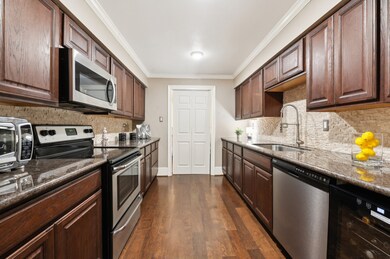 Galley kitchen with stainless appliances and granite counter-tops