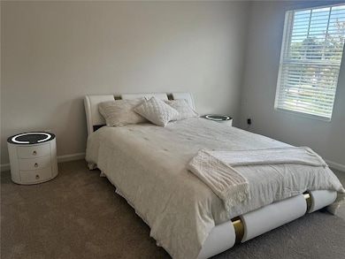 Bedroom with carpet floors and baseboards