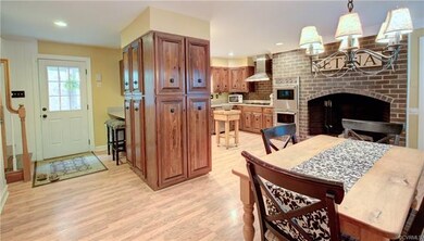 Large kitchen with wood burning fireplace with gas
