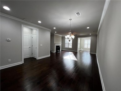 Unfurnished living room with crown molding, a chan