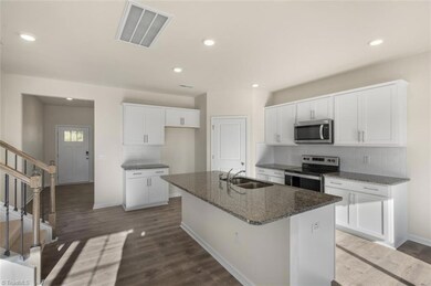 Open kitchen/dining/family room. Photo is representative