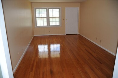 Living room with beautifully refinished floors.
