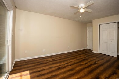 Unfurnished bedroom with dark wood-style flooring,