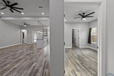 Unfurnished living room featuring hardwood / wood-