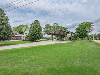 View of home's community with a yard, dirt drivewa