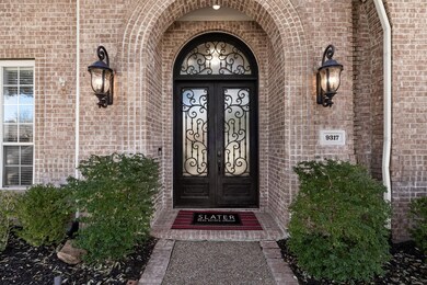 Doorway to property with brick siding and french d