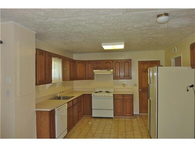 Kitchen. View of kitchen w/oak cabinetry, neutral 